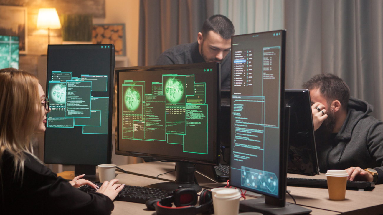 Female hacker with her team of cyber terrorists making a dangerous virus to attack the government.