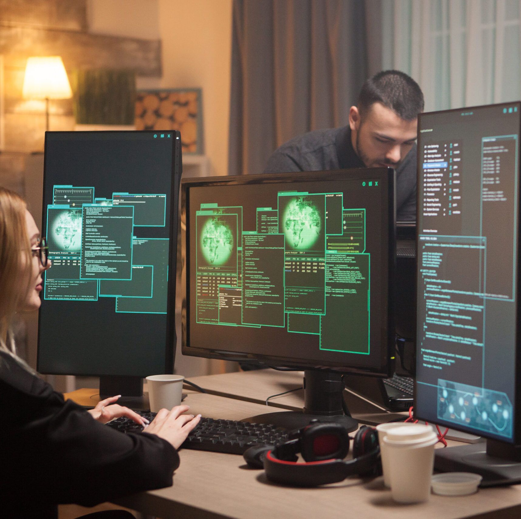 Female hacker with her team of cyber terrorists making a dangerous virus to attack the government.