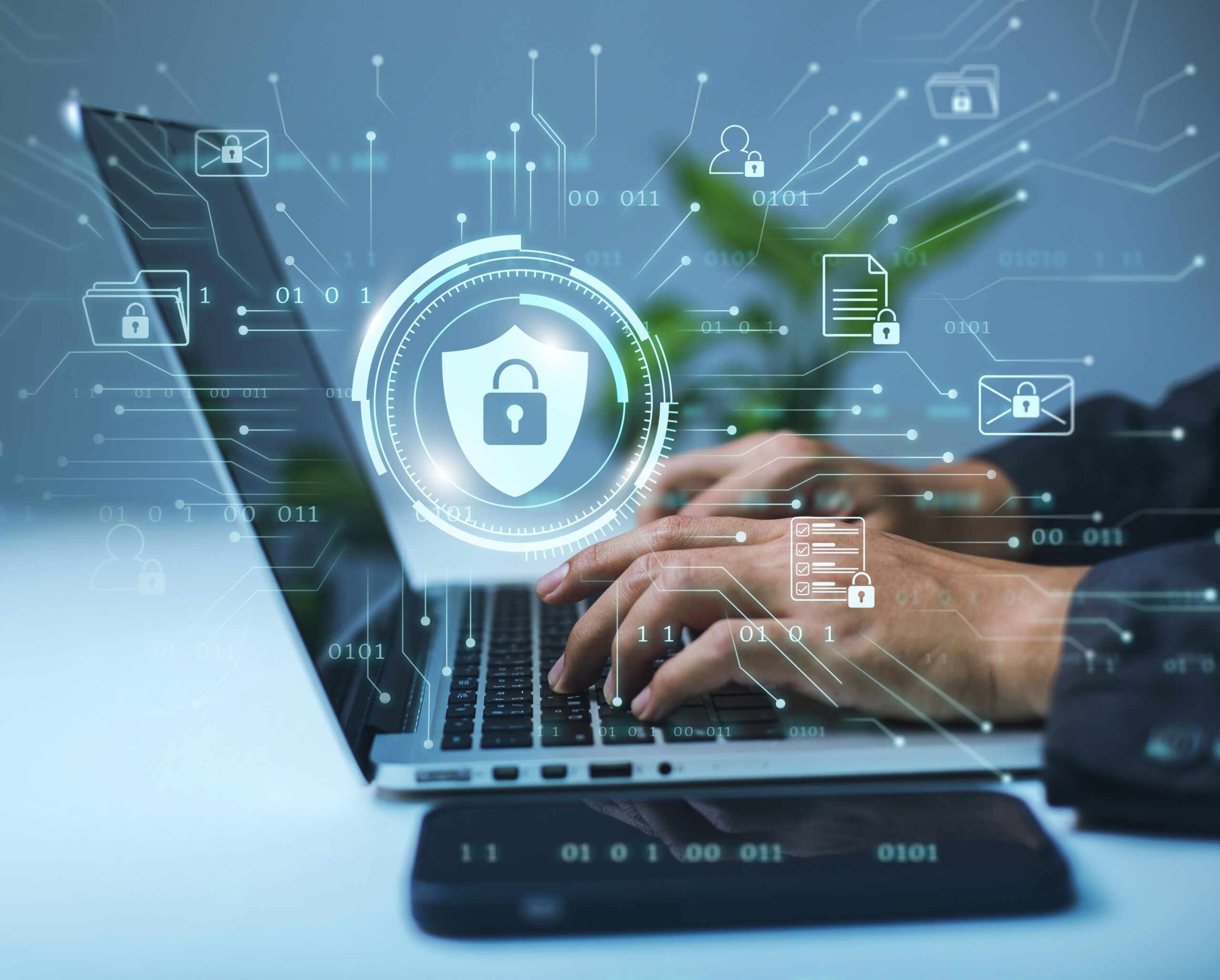 A businessman works on his laptop at home with a virtual display showing a symbol to signify cyber security privacy and online data protection